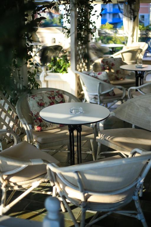 a group of tables and chairs on a patio at Hotel Monarch in Elbasan