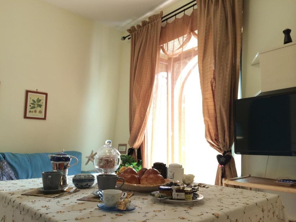 una mesa con comida en ella con una ventana en Casa Cajo en Taormina