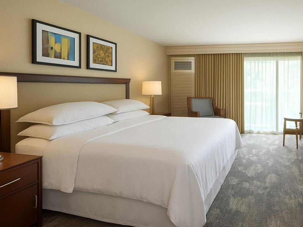 a large white bed in a hotel room at Sheraton Kauaʻi Resort Villas- STUDIO in Koloa