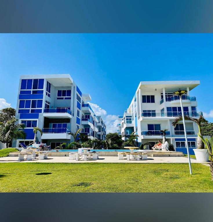 two tall apartment buildings next to a swimming pool at Luxury Cabarete East Condominiums in Cabarete