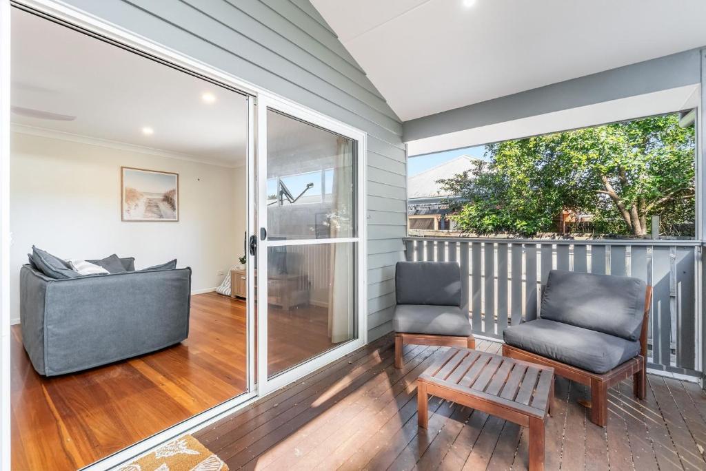 a screened porch with two chairs and a table at Iluka Sea Spray in Iluka