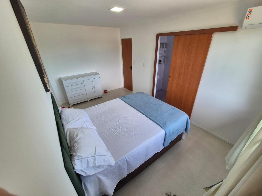 een kleine slaapkamer met een bed en een kast bij Condomínio Residencial Tiê in Camassari