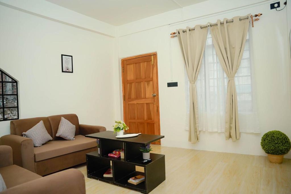 a living room with a couch and a table at Mareenda's Haven in Shillong