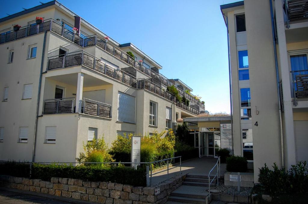 a white building with balconies on the side of it at Boardinghouse HOME - adults only - in Konstanz