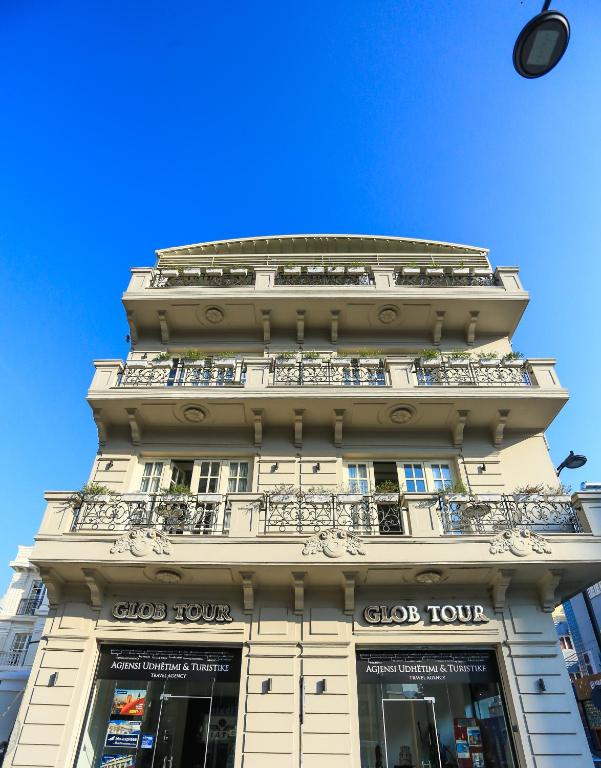 a building with a clock tower on top of it at Hotel Monarch in Elbasan