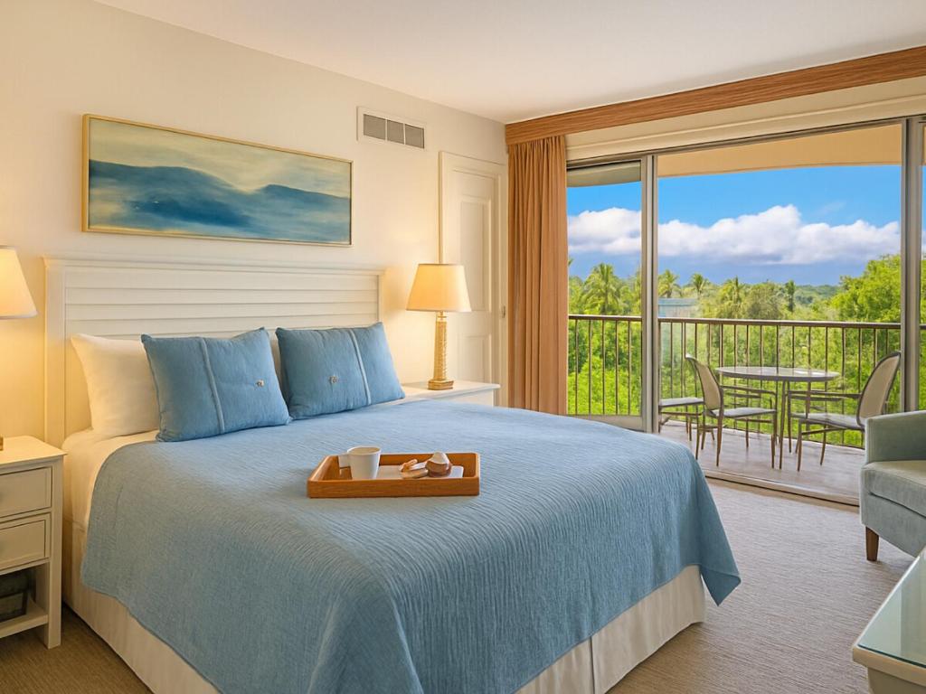 a bedroom with a bed and a balcony with a table at The Westin Kāʻanapali Ocean Resort Villas- Island View STUDIO VILLA in Lahaina