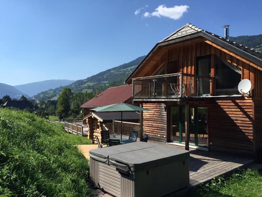 a wooden house with a deck and a balcony at Woody Park Chalet 14 in Kaindorf