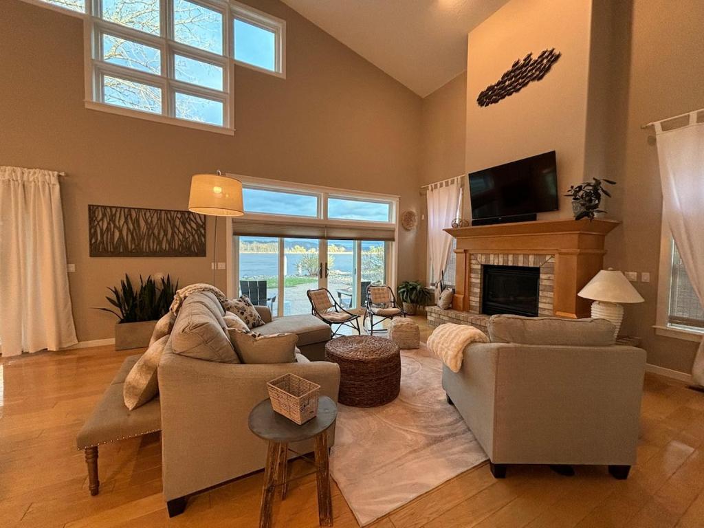 a living room with a couch and a fireplace at Mississippi waterfront getaway-Dogs Welcome! in Brownsville