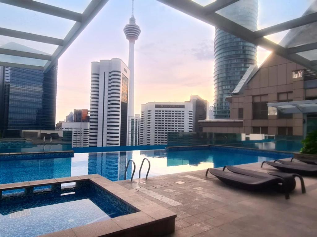 a swimming pool with a view of the city at Cormar Residences Kuala Lumpur in Kuala Lumpur