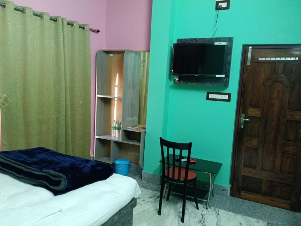 Jāmbにあるsky birds hotel & restaurantのベッドと椅子とテレビのある寝室