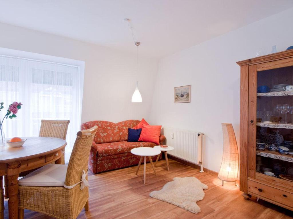 a living room with a couch and a table at Fewo Jule in Norderney
