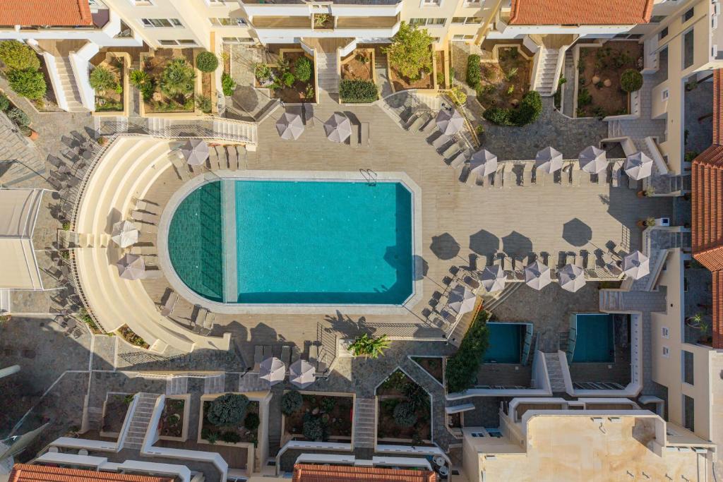 an aerial view of a swimming pool in a building at Alexander House Hotel in Agia Pelagia