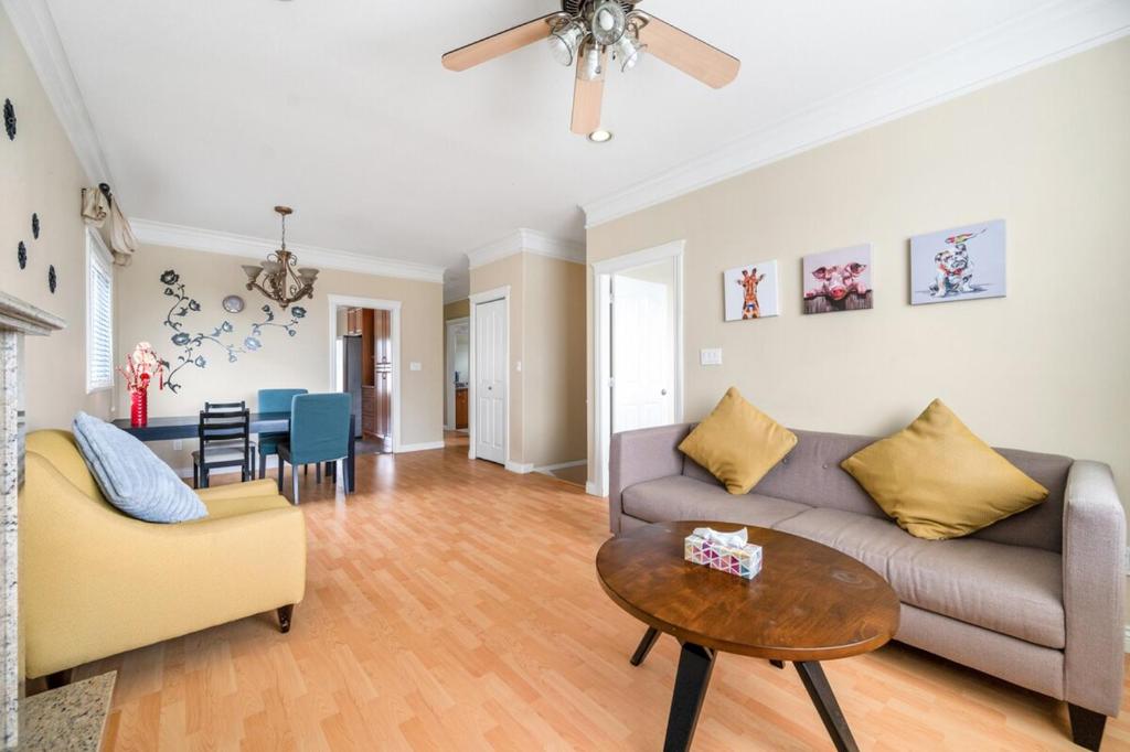 a living room with a couch and a table at Cozy Stay in Metrotown Steps to SkyTrain in Burnaby