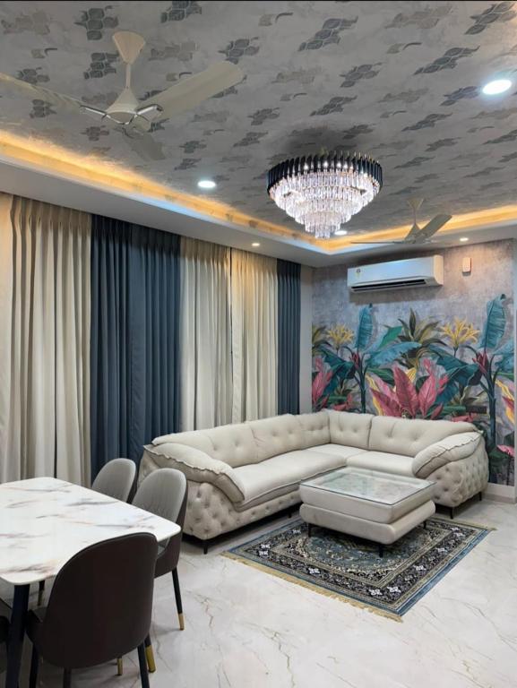 a living room with a couch and a table at Madhav Villa in Jaipur