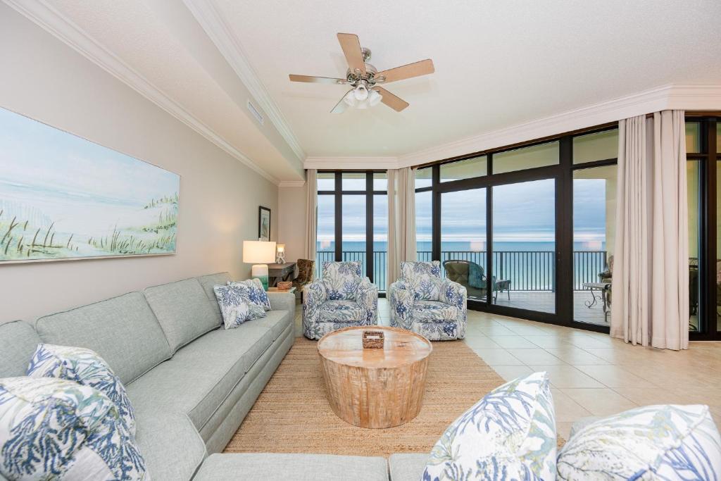a living room with a couch and chairs at Phoenix West 1002 in Orange Beach