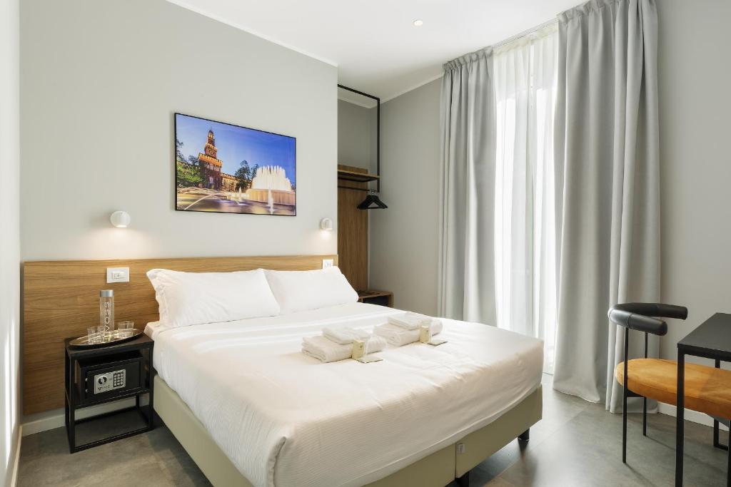 a bedroom with a large white bed and a window at Hotel 22 Marzo in Milan