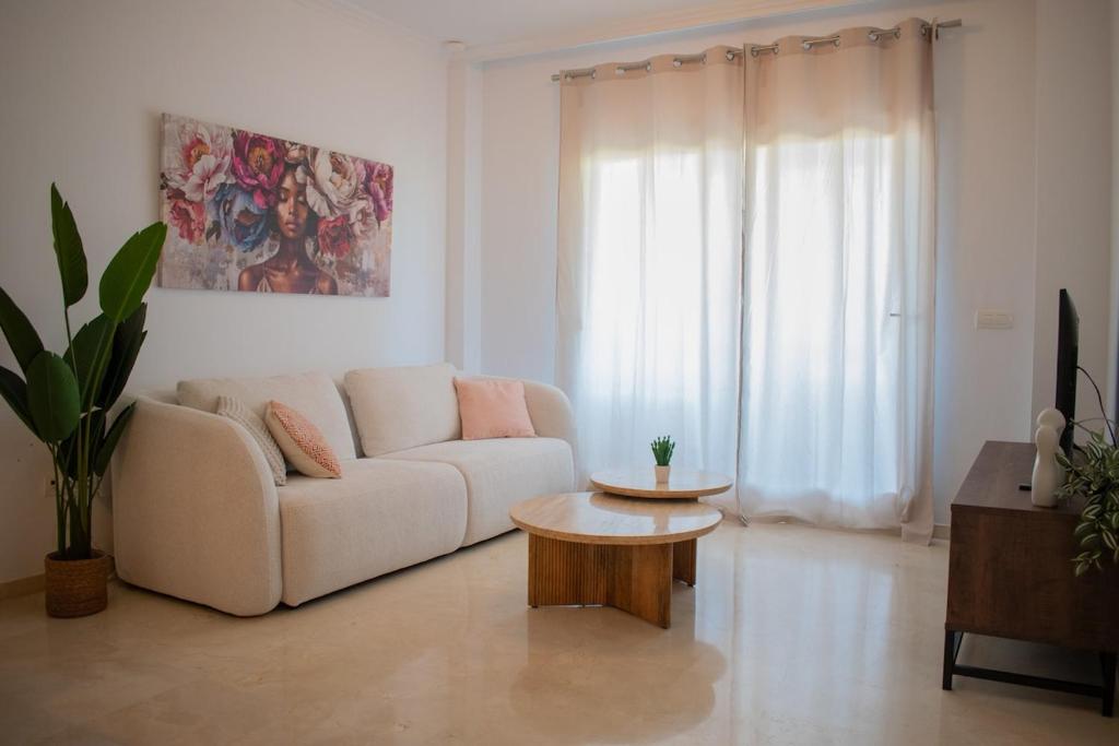 a living room with a couch and a coffee table at 2BR Ontspannen vakantiewoning in Casares