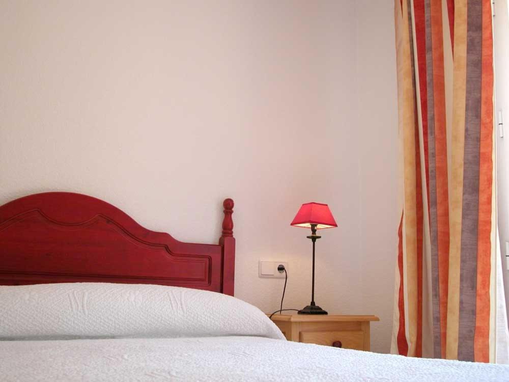 Postel nebo postele na pokoji v ubytování Apartamentos Oasis de las Palmeras