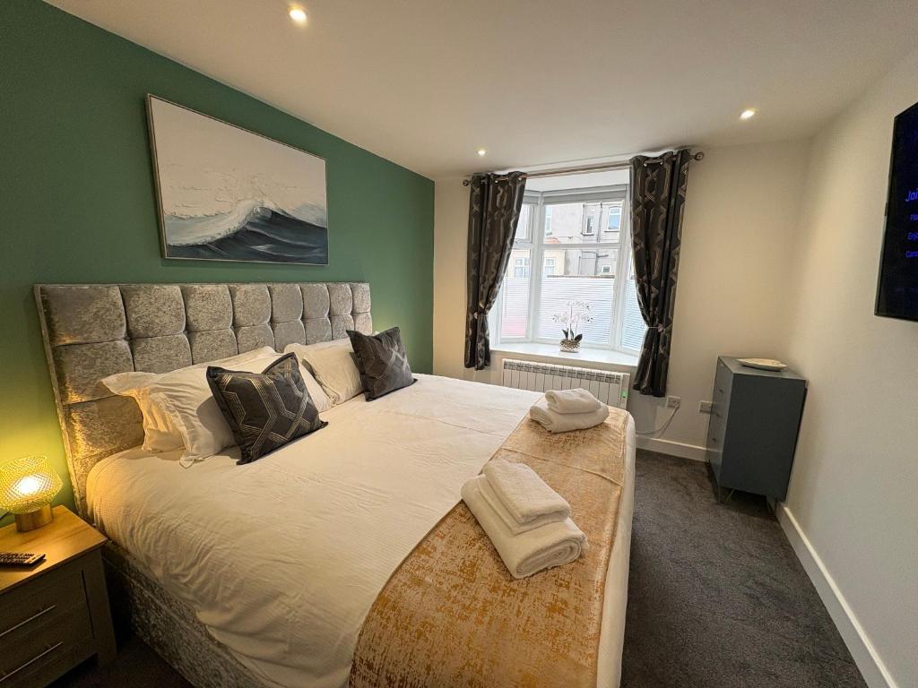 a bedroom with a large bed and a window at Cleveleys Town Centre in Blackpool