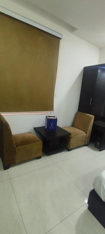 a room with two couches and a table with a box on it at Glory prime suits in New Delhi