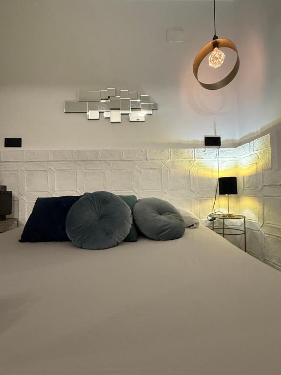 a bedroom with a bed with two pillows on it at Gollum-Goretti House in Mairena del Aljarafe