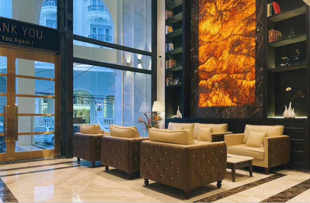 a lobby with couches and chairs in a building at Maccal Boutique Hotel Dalat in Da Lat