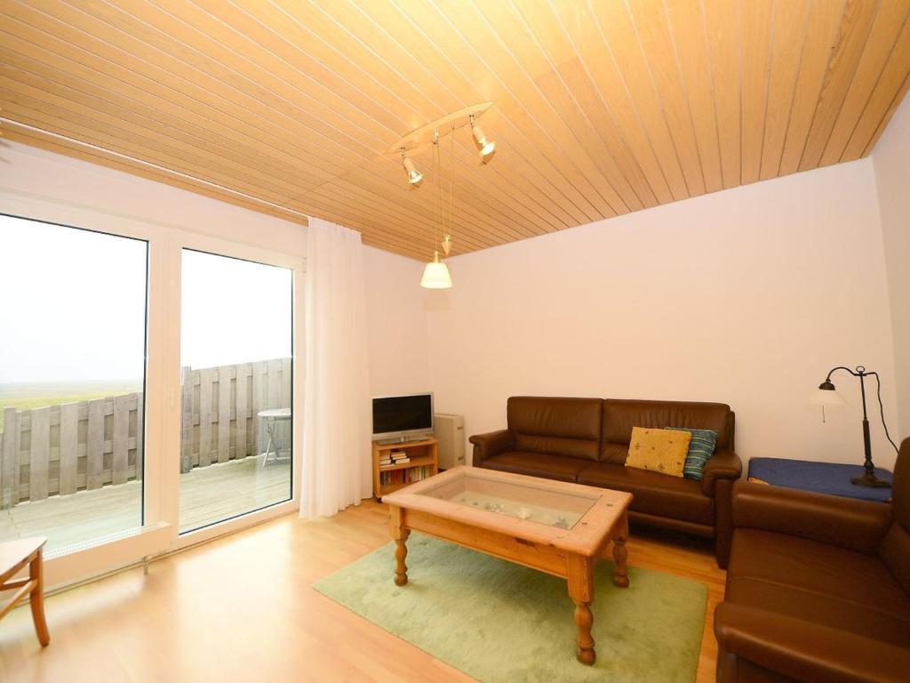 a living room with a couch and a coffee table at Haus Nixe Kachelot in Juist