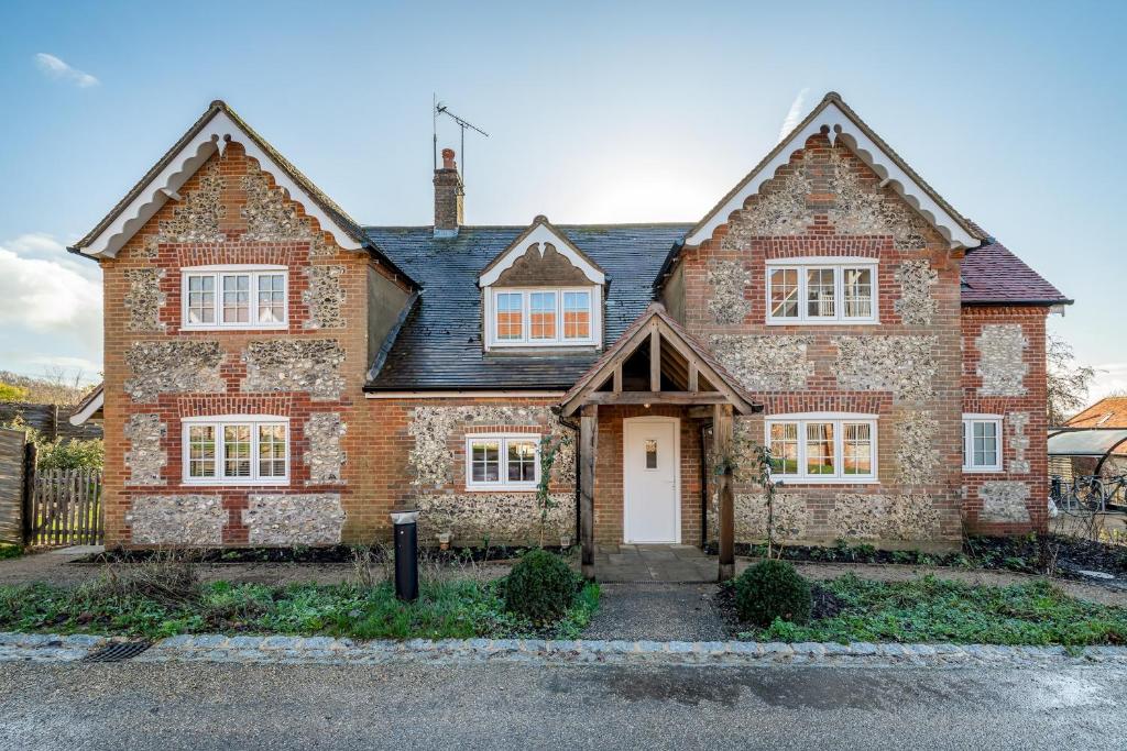 a large brick house with a white door at Garsington Studios Chilterns Farm House - Pass the Keys in Stokenchurch