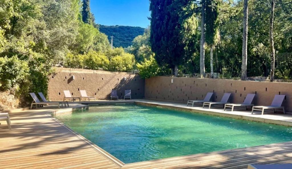 a swimming pool with lounge chairs and a swimming pool at Camping 3 étoiles - Piscine - ccbccbe in Sartène