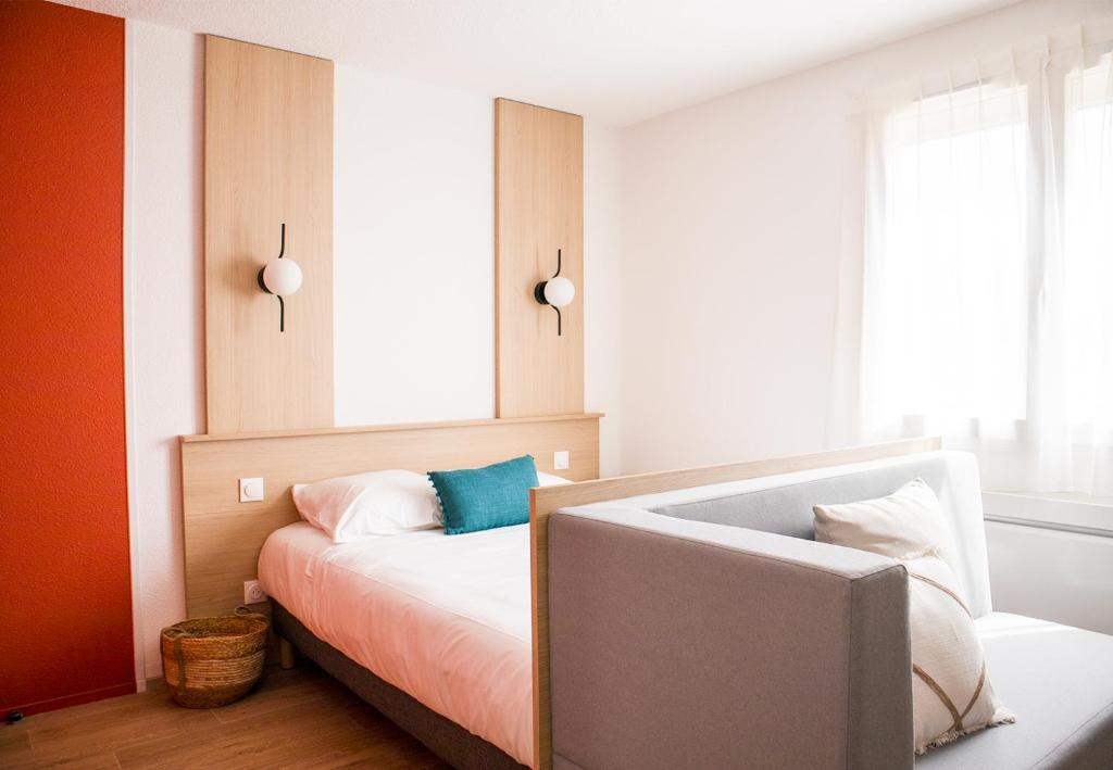 a bedroom with a bed with a sink in it at Sweetly Isatis Mérignac in Mérignac