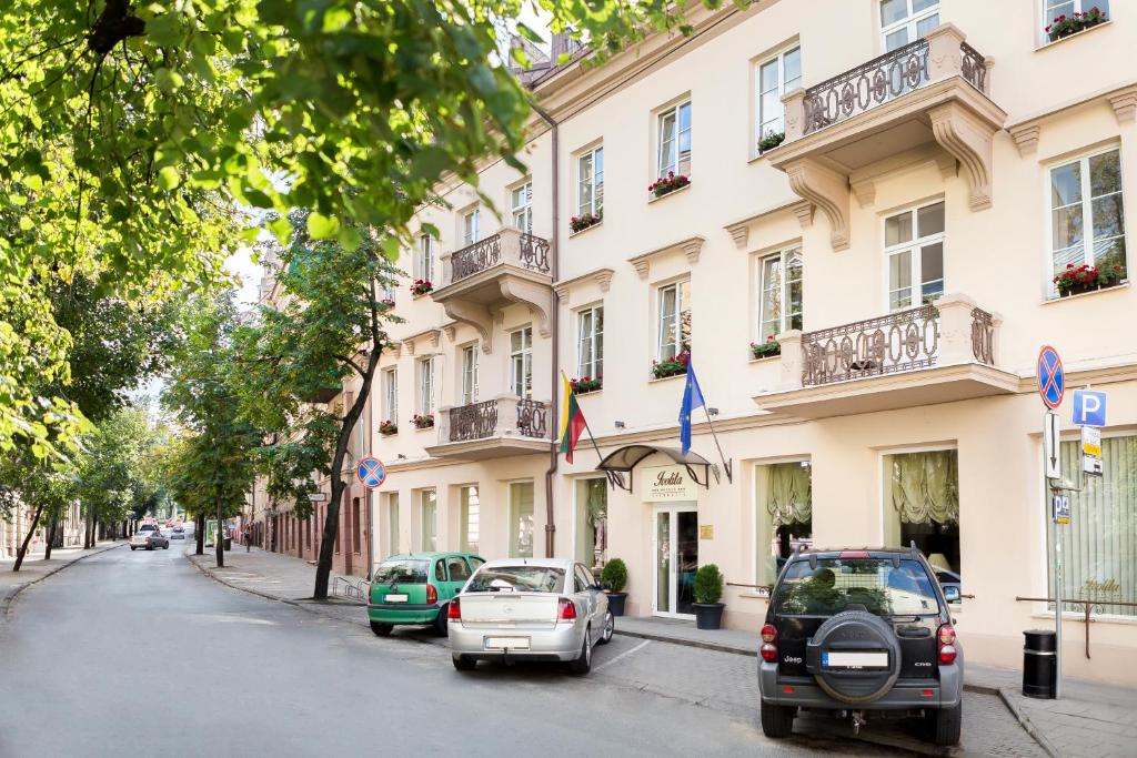 a street with cars parked in front of a building at Ivolita Vilnius in Vilnius