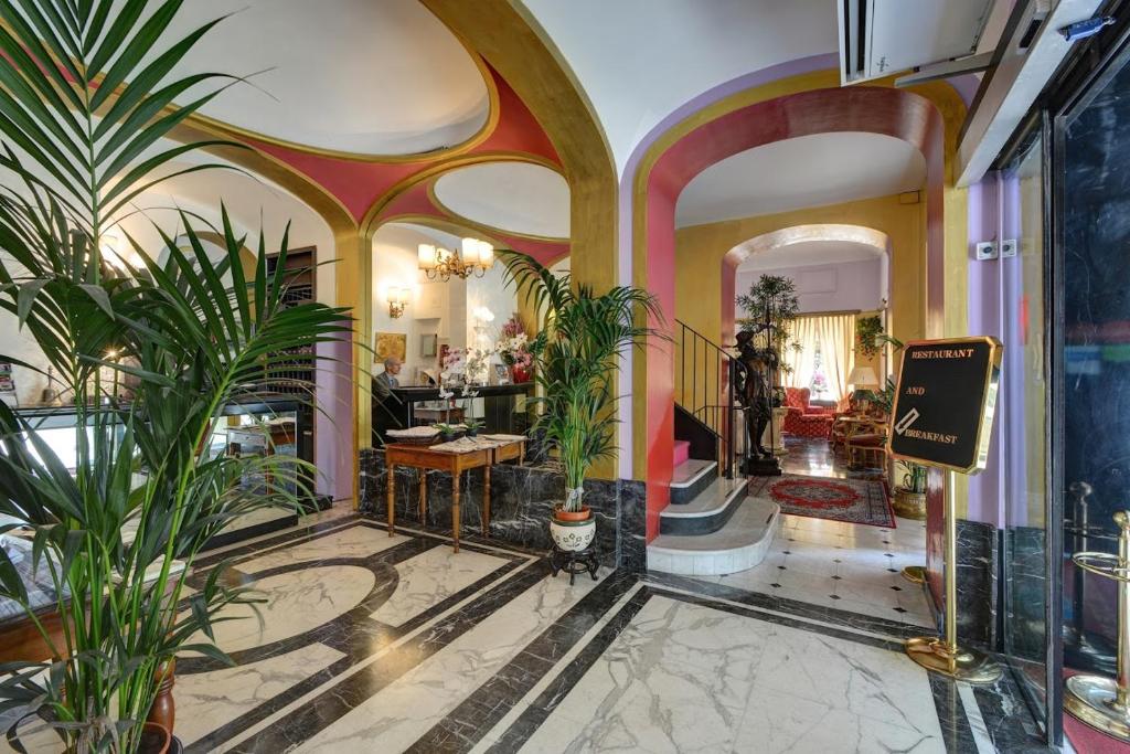 a lobby with potted plants in a building at Hotel Due Mondi in Turin