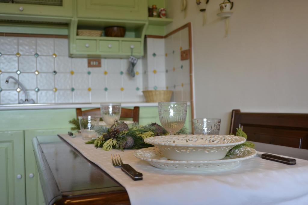 a kitchen with a counter with bowls and glasses on it at Number 51 in Roccaraso