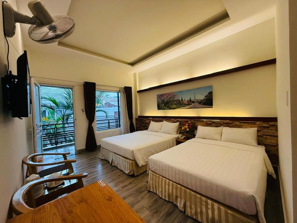 Ένα ή περισσότερα κρεβάτια σε δωμάτιο στο TUK Villa Hotel