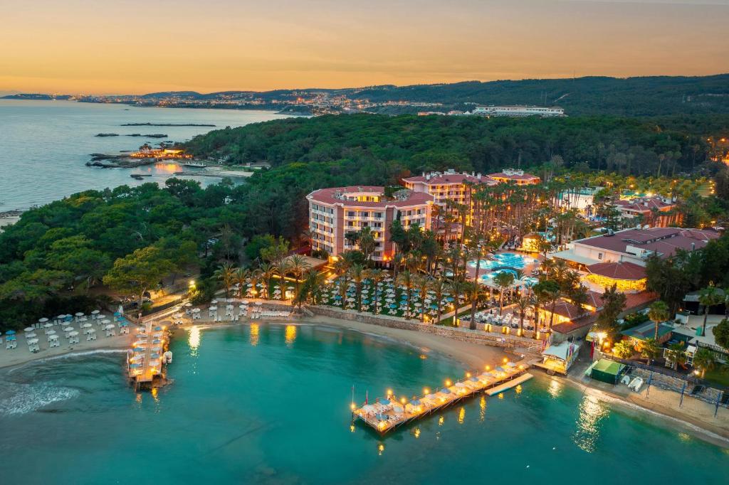 an aerial view of a city with lights in the water at Utopia Resort & Residence in Avsallar