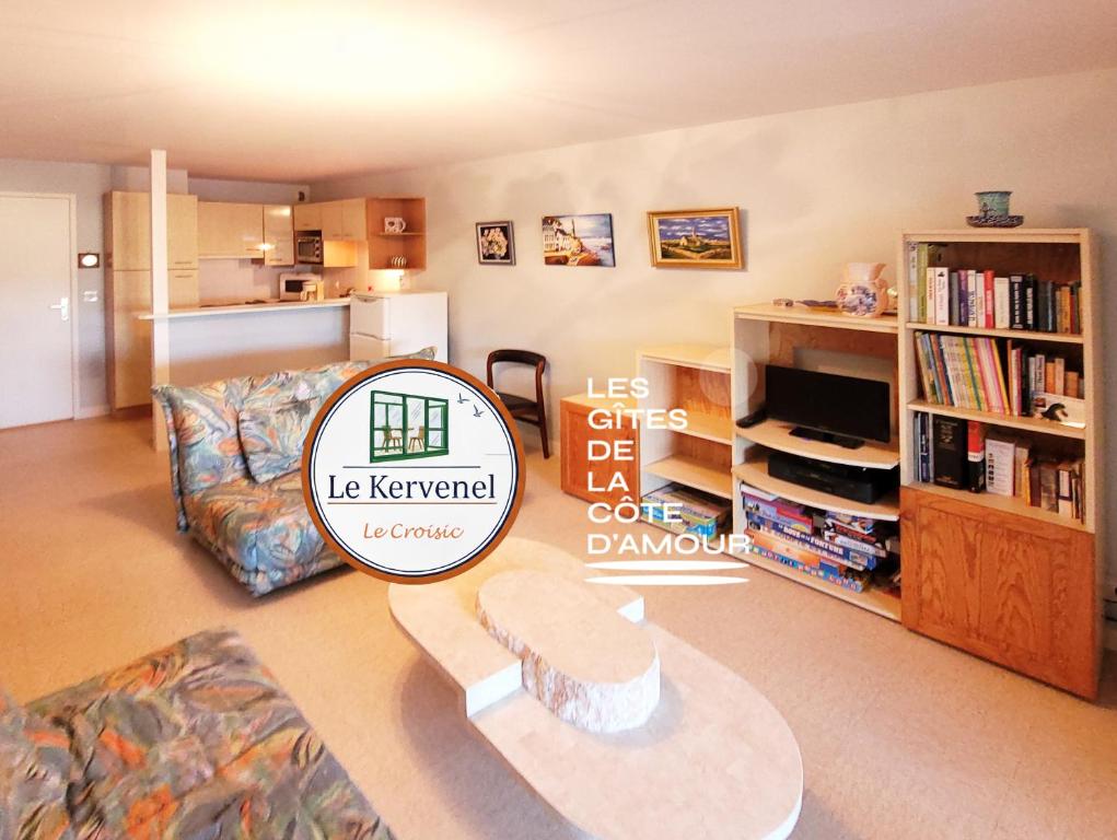 a living room with a couch and a table at Le Kervenel - Les Gîtes de la Côte d'Amour in Le Croisic