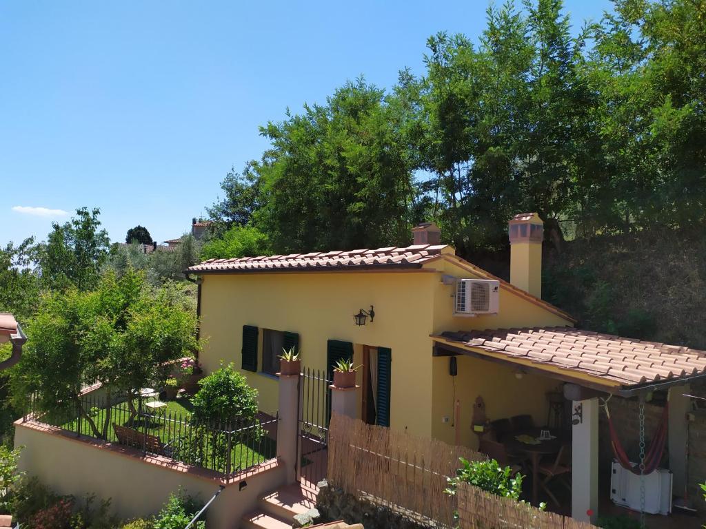 a small yellow house with a fence at Wonderful Rustic Cottage with Garden-Only Adults in Pistoia