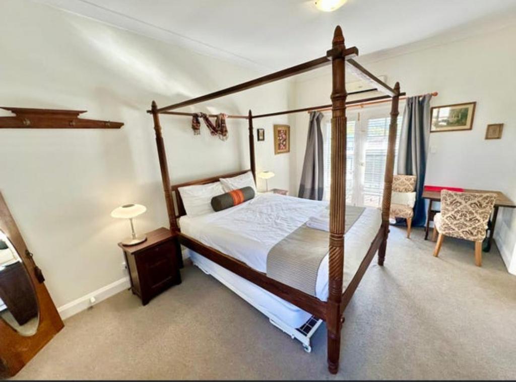 a bedroom with a four poster bed in a room at Beautiful Heritage Style Room in York in York
