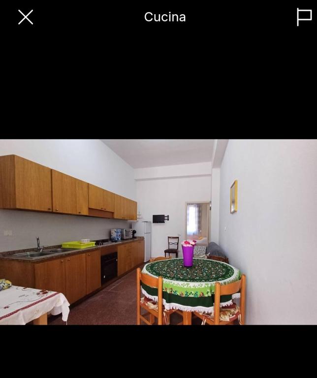 a kitchen with a table with a pink candle on it at Florina Appartment in Capo dʼOrlando