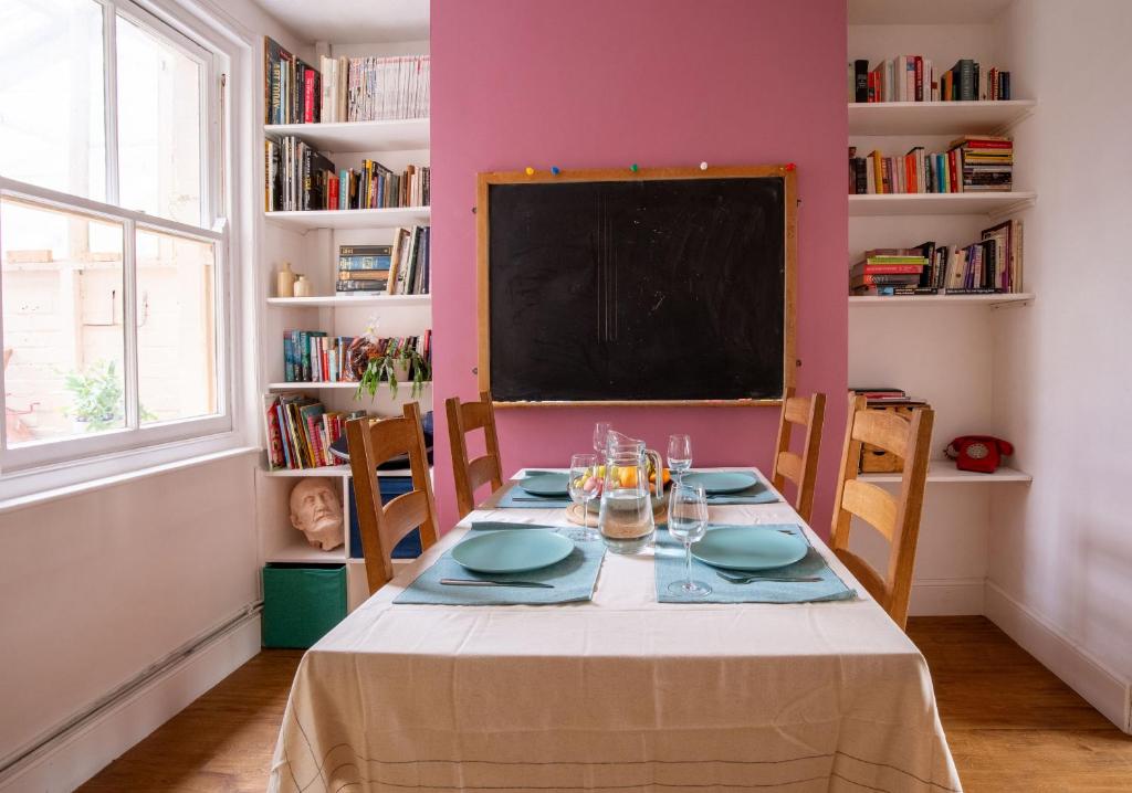 a dining room with a table and a chalkboard at Exesixteen in Exeter