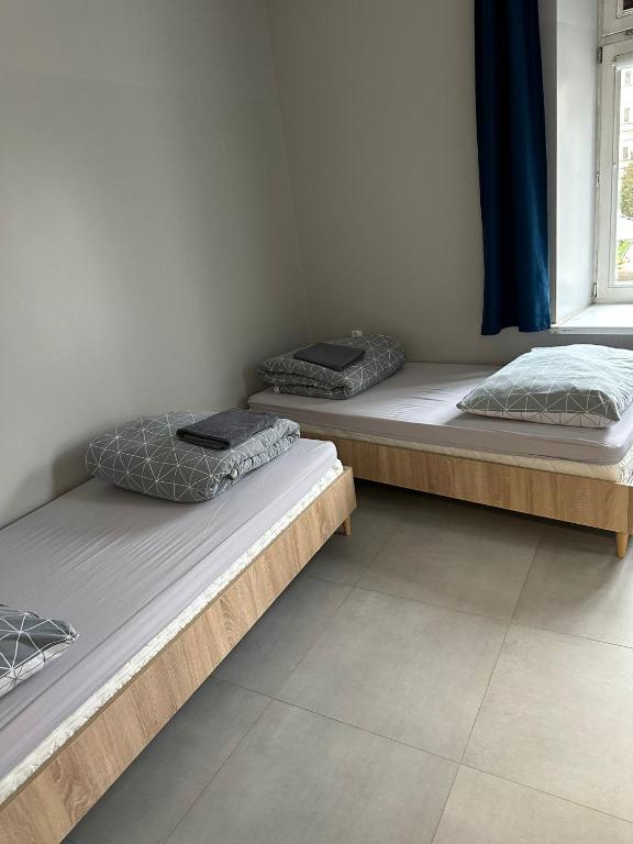 two twin beds in a room with a window at StarBal in Radom