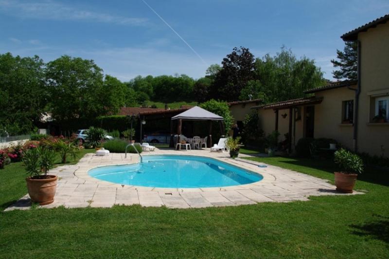 a swimming pool in a yard next to a house at Marievalerianne in Mirefleurs