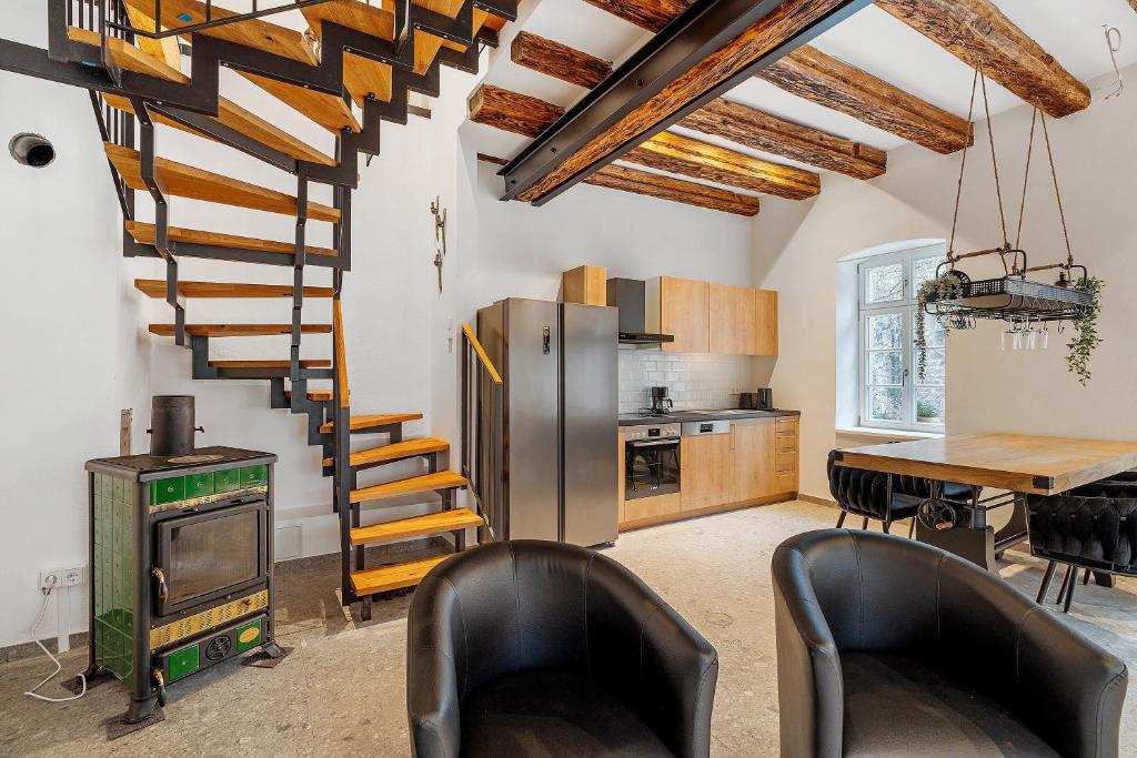 a kitchen with a spiral staircase and a table at Historische Werkstatt in Gernsbach
