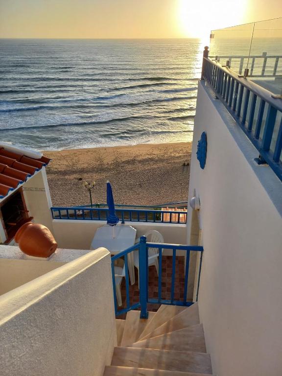 a view of the beach from the balcony of a cruise ship at Casa da Praia - Vista Mar in Ericeira