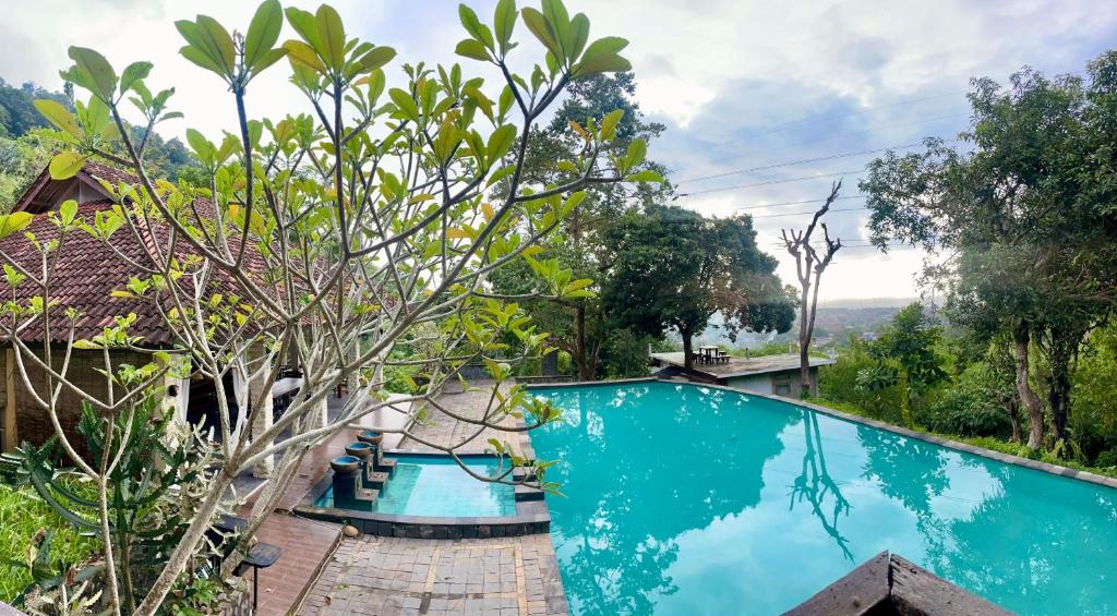 an image of a swimming pool at a resort at Covehill Green Resort in Pelabuhan Ratu