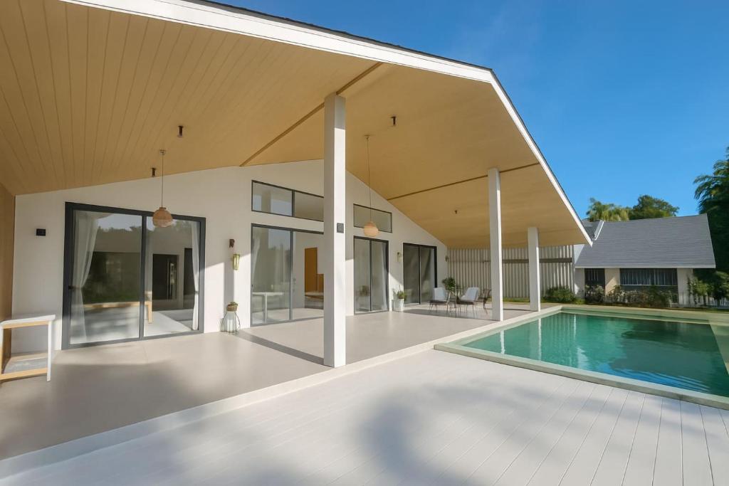 an external view of a house with a swimming pool at Cocolane Villa 2 in Ban Madua Wan