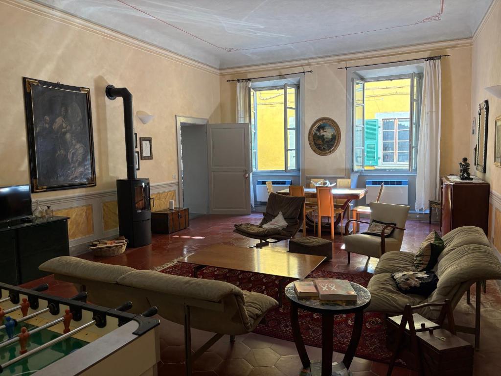 a living room filled with furniture and a table at La Piscina nel Borgo in Bagnone