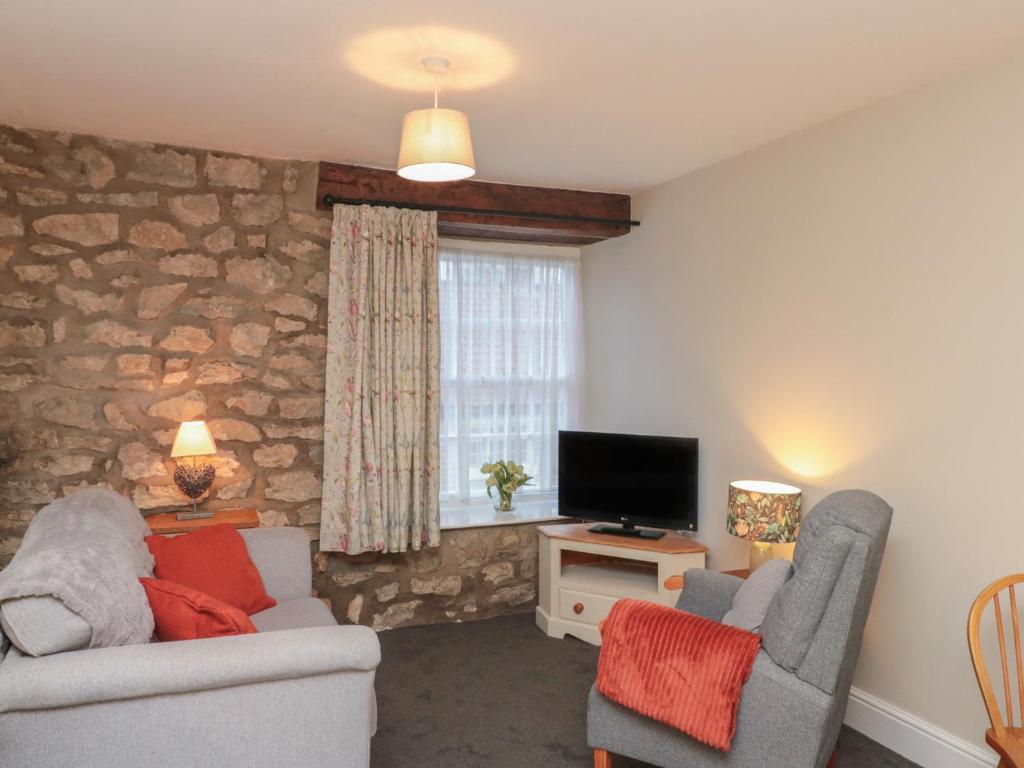 a living room with two chairs and a television at Beck View in Pickering