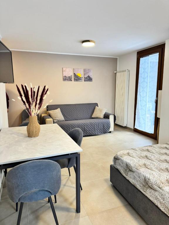 a living room with a couch and a table at Tonale Sweet House in Passo del Tonale