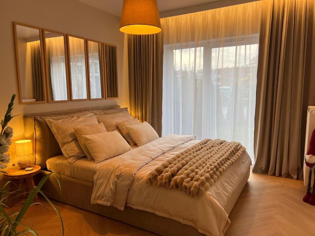 een slaapkamer met een groot bed en een groot raam bij Cisowa Garden Suite in Świdnik